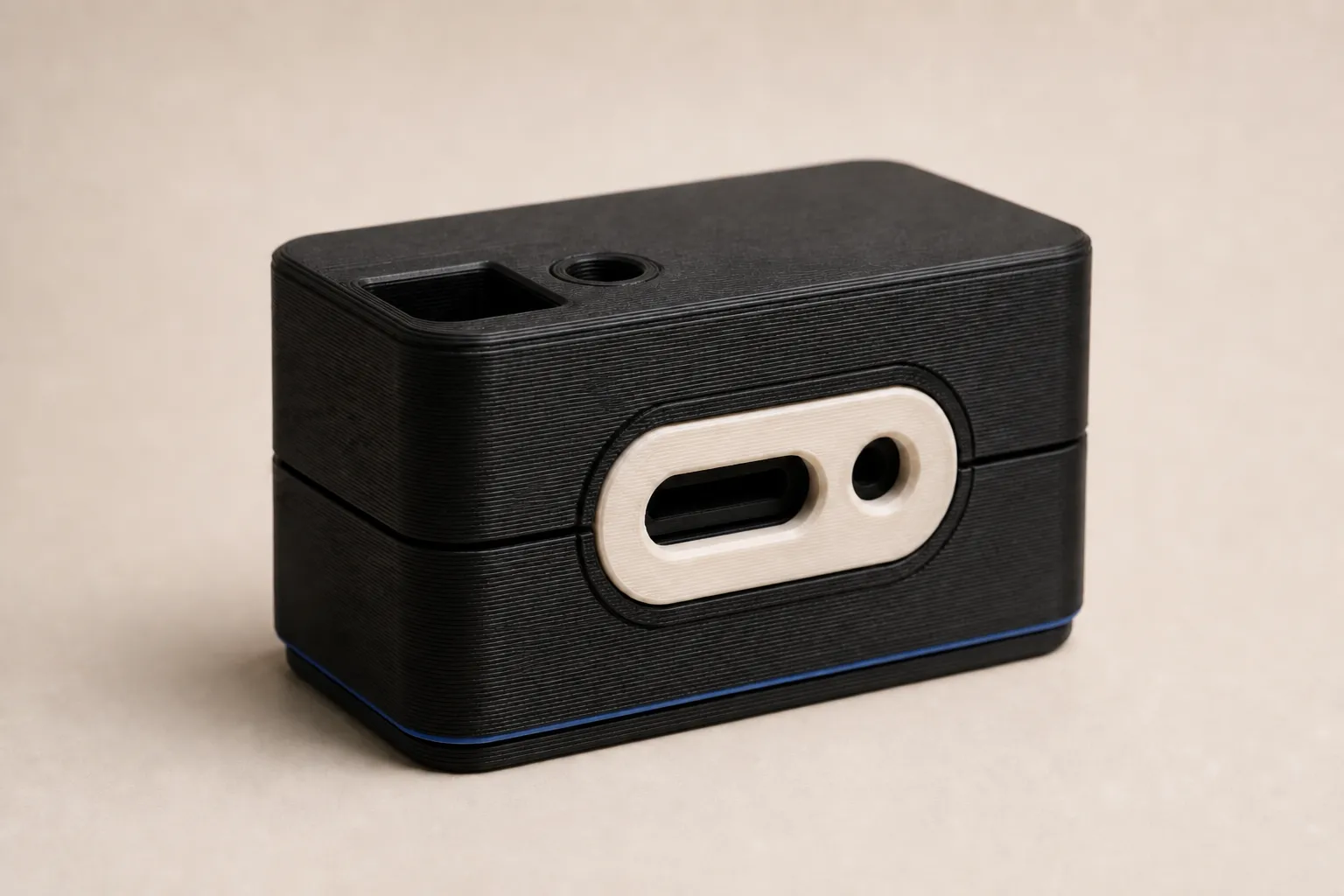 A single black FDM enclosure with a warm off-white inset faceplate.