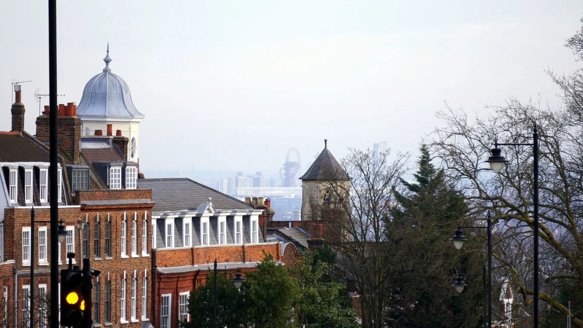 London brick terraces and rooftops with the city skyline in the distance.